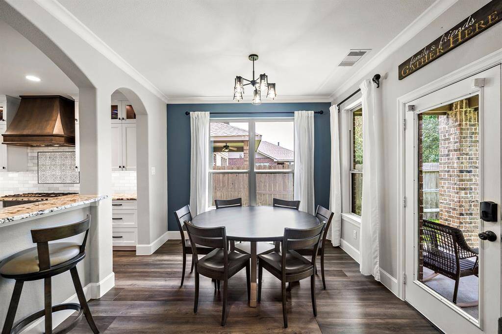 The kitchen flows right into sunny breakfast room with large windows.