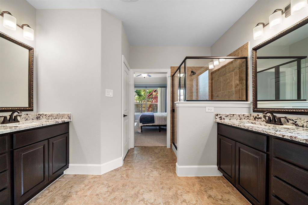 Dual granite-topped vanities provide plenty of space to spread out.