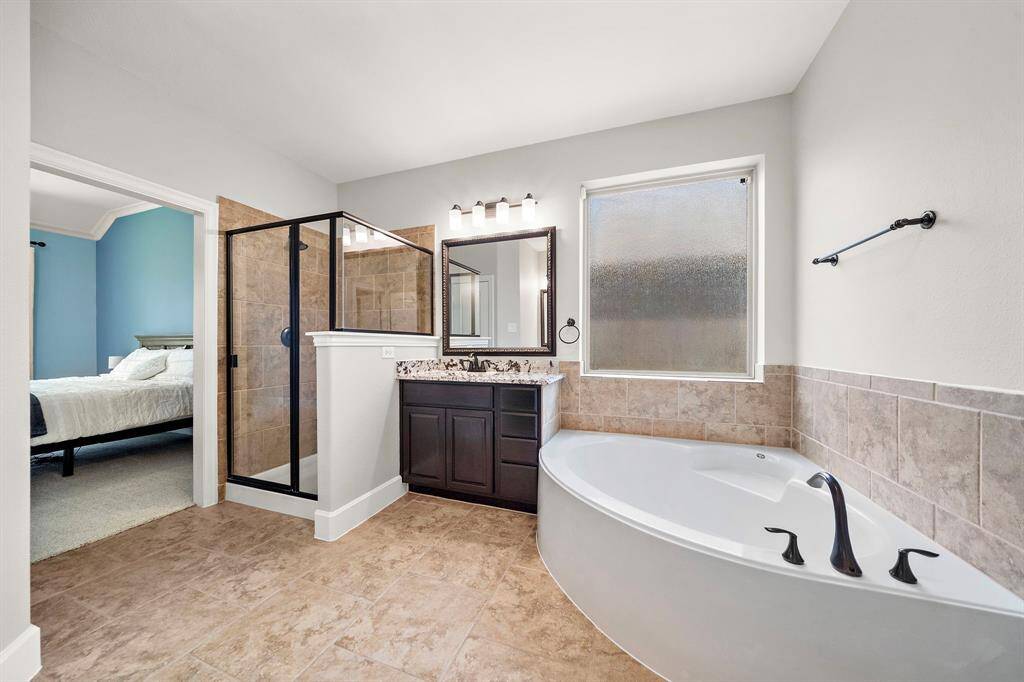Oversized walk-in shower with sleek tile work and upgraded fixtures for a luxury feel.