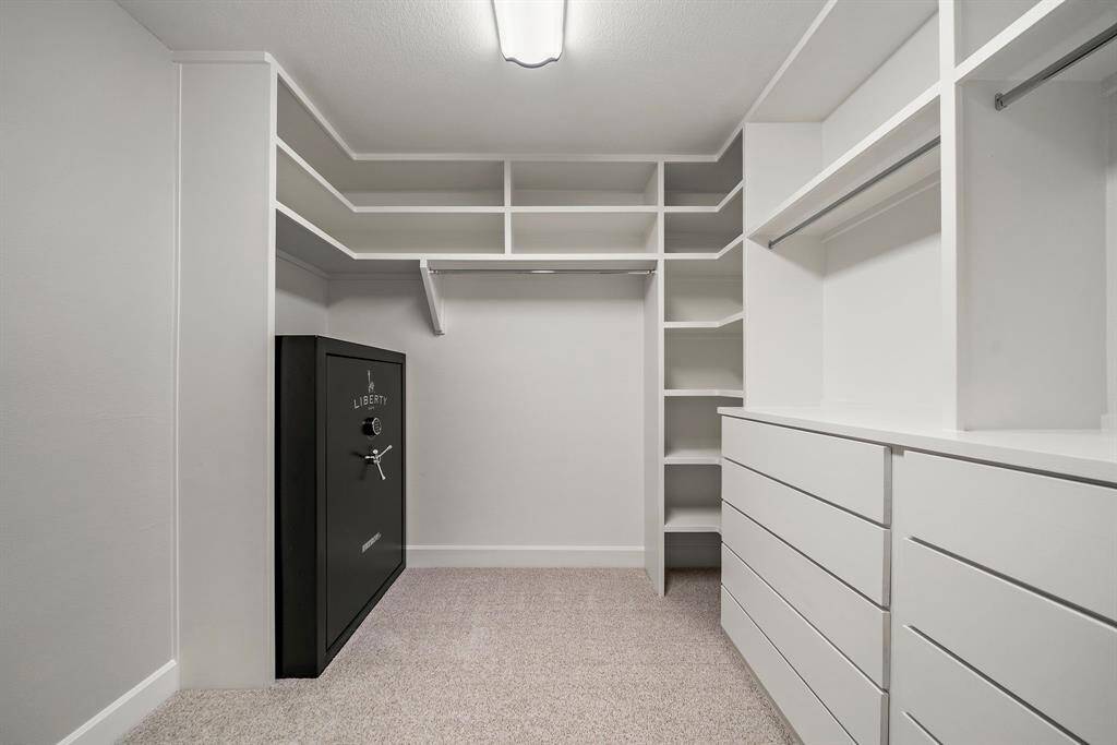 Safe stays in the oversized walk-in closet with custom solid wood built-ins and 10-drawer soft-close dresser.