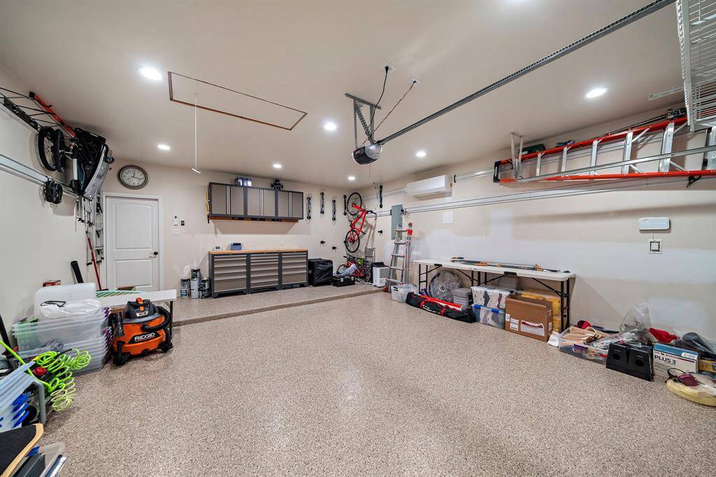 Extra deep garage has professional epoxy floor, custom lighting, and lot of built ins on the walls and ceilings. Fully decked XL storage attic space above the garage with solar panel ventilation for cooling.