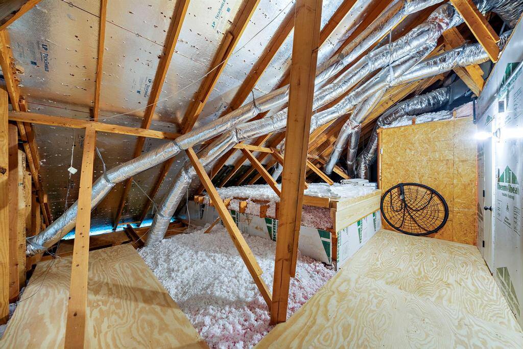 Fully decked attic storage above with solar-powered ventilation.