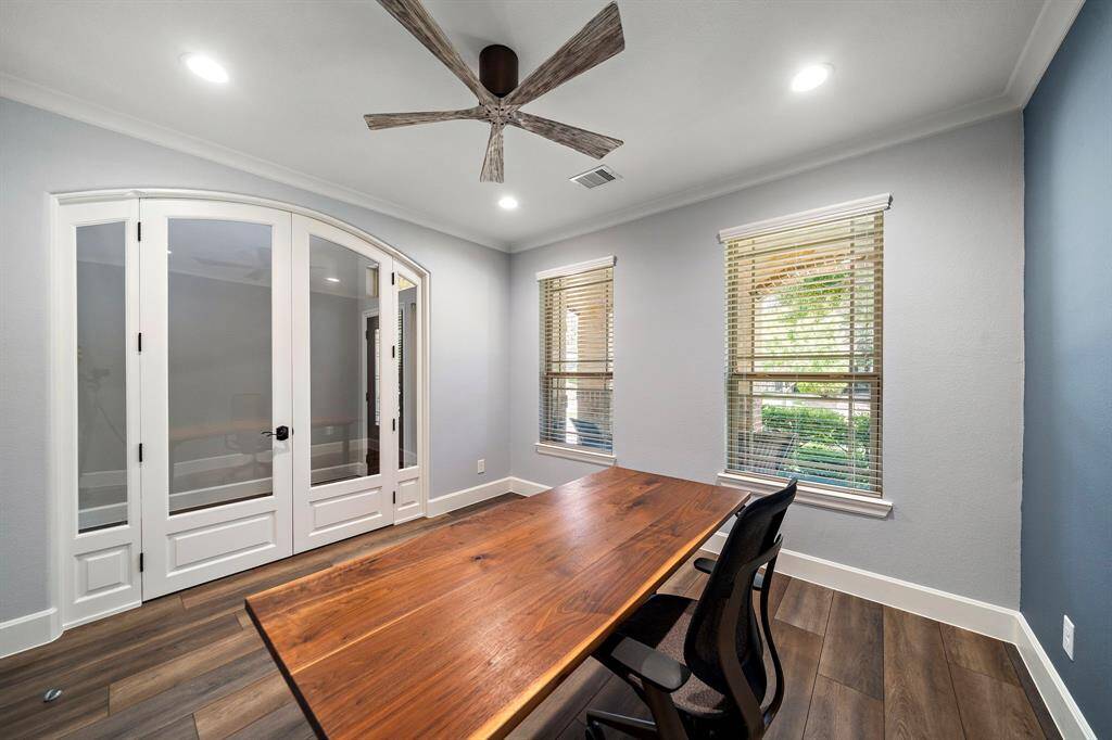 Custom oversized arched solid hardwood French double office doors with exterior-grade insulated double-pane glass.  Isolates sound between office and home.