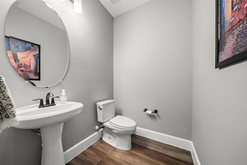 Spacious half bathroom conveniently located just down the hall from the front entrance.