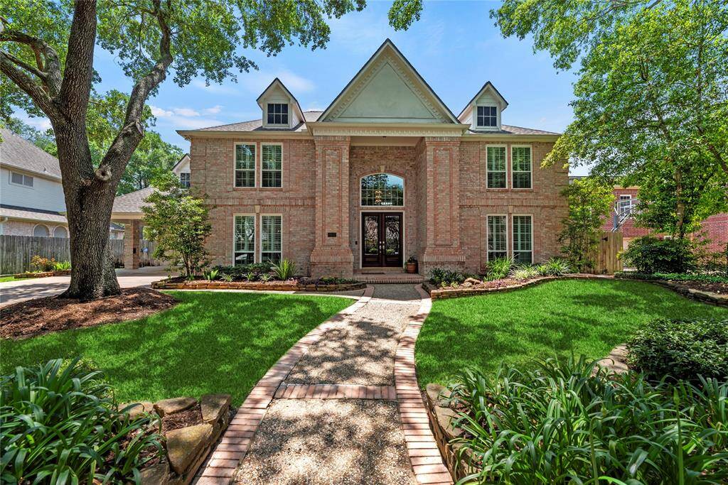 Charming two-story brick home nestled on an 11,180 sqft lot, featuring a beautifully maintained front yard and offering 4,744 sqft of spacious living.