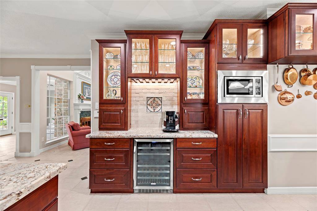 Alternate view of the kitchen highlights the functional wine and coffee bar, complete with a built-in wine cooler—perfect when entertaining or just enjoying a quiet evening at home.