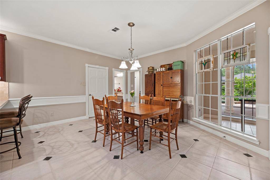 Bright breakfast area with large windows, allowing for natural light. Adjacent to the kitchen, offering easy access.