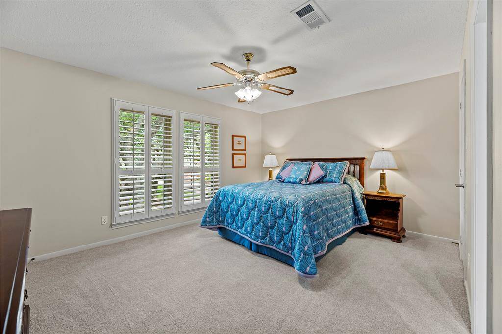 This secondary bedroom (4) features carpet flooring, ceiling fan, and windows with plantation shutters.  Bed # 4 measures 15.7x14.6