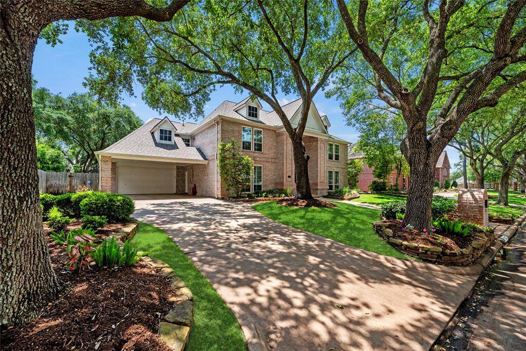 Alternate view of the front of the home featuring the driveway leading to the three-car garage.