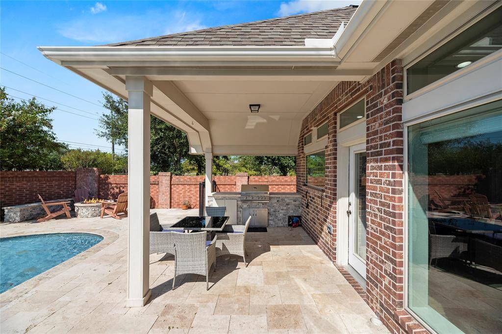The large covered patio has a functional grill and plenty of space for shaded seating.