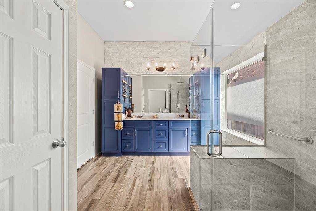 The updated primary bath is elegant with sleek lines and a wonderful shower.