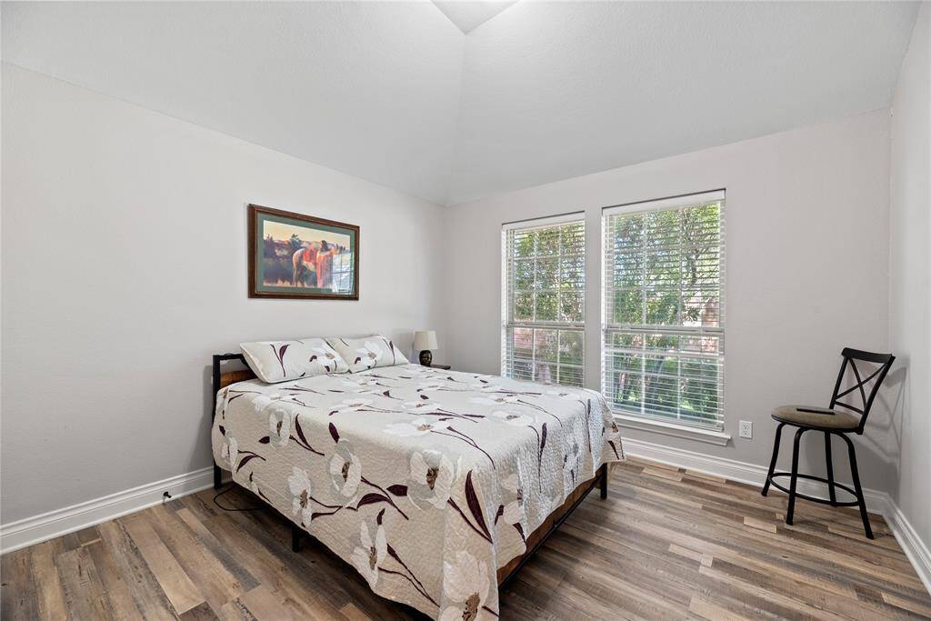 The same upgraded flooring extends to this bright yet cozy bedroom.