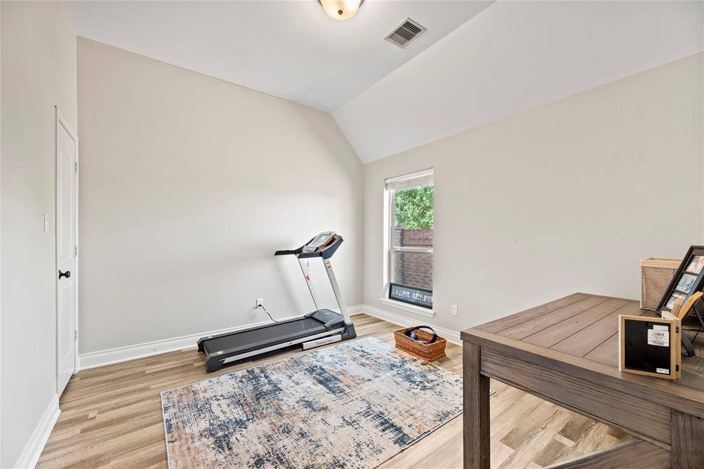 Across the hall is another bedroom, currently used as an exercise room.