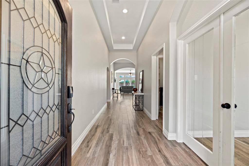 The leaded glass door opens to an inviting hallway with the home office immediately on your right.