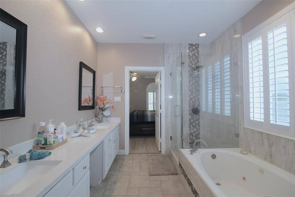 Primary bathroom has a garden tub and standing shower combo