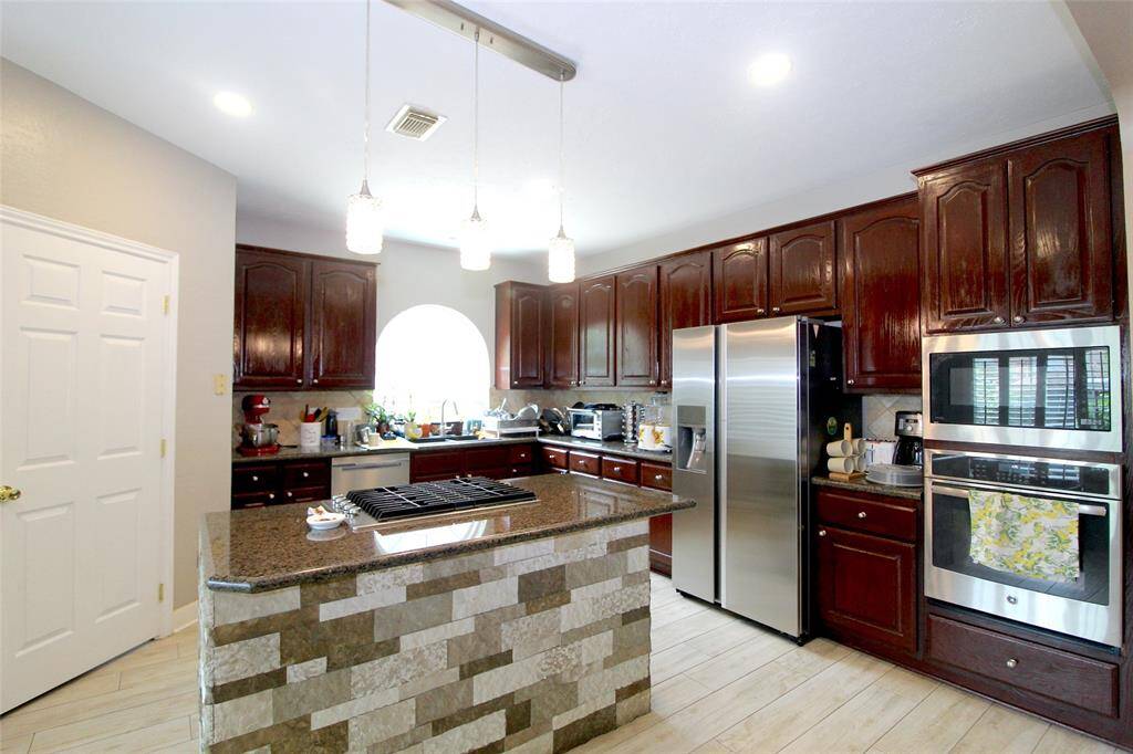 Kitchen has an island with cooktop
