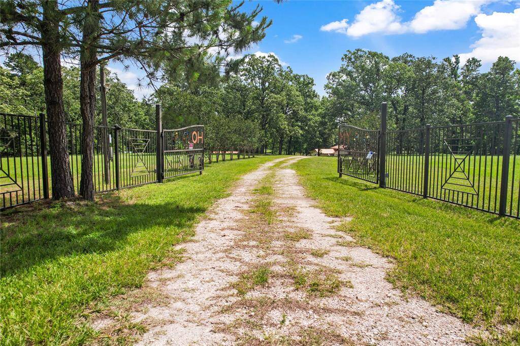 Welcome to 202 Burning Tree Raod! This tree lined driveway takes you down to the main home and pond.