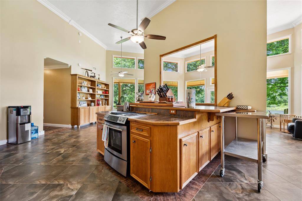 Kitchen view through to the dining area. Large island provides lots of storage. Jenn Air range. That hutch in the dining area is included in sale.