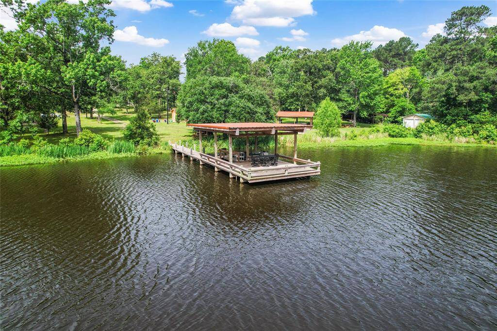 Covered boat dock with 2 slips. Electric boat lift. Lights. Irrigation pump from pond. Fish from the pier or paddle out! Bring your bathing suit for a swim!