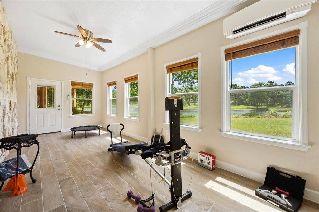 Hate going to the gym? You will love this flex space as a workout room. How about that pond view? Plus access door out to the covered patio. Walk around the pond to end your morning workout routine.