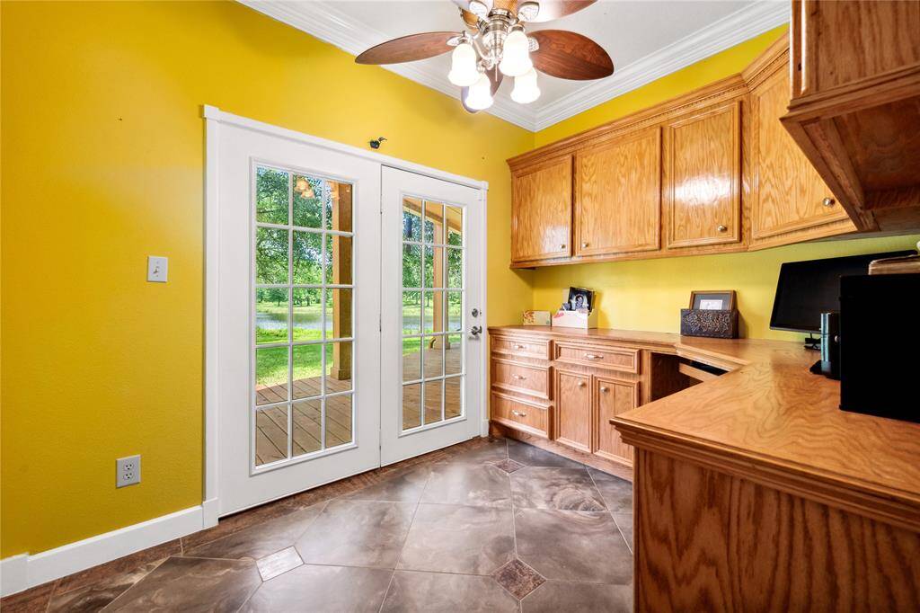 Home office with fully built ins work center! Double French doors allow you to step right outside for breaks!