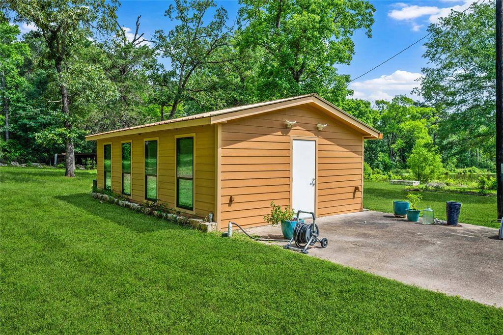 416 SF detached building currently used as Art Studio. Built in tables and drawers/storage stay. YES it has AC!