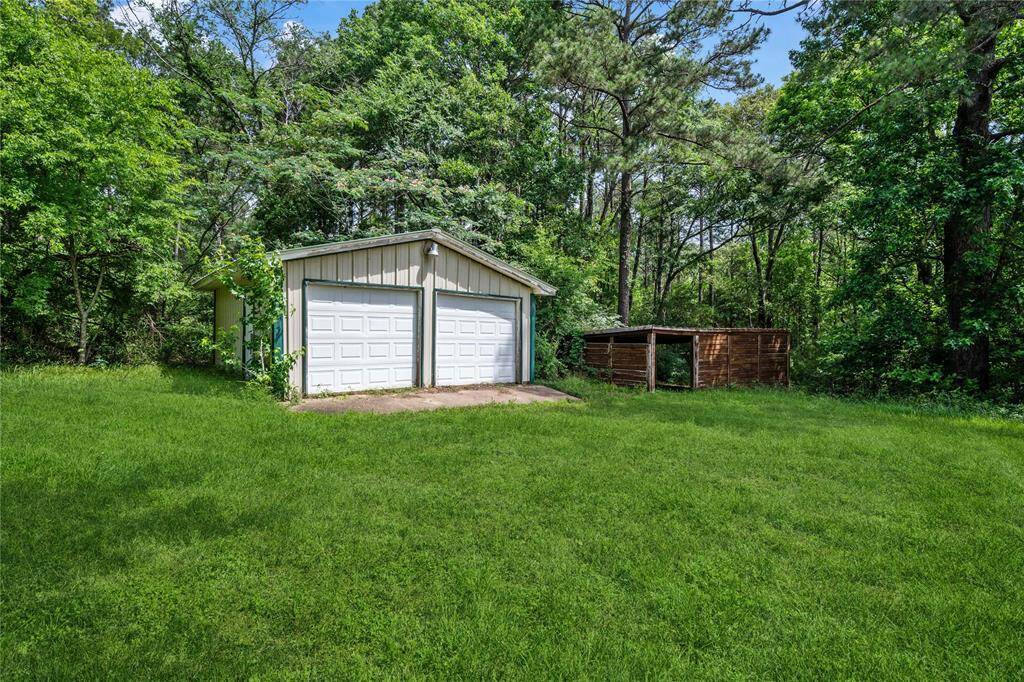 Storage shed/workshop has 2 roll up doors so all your yard equipment will be enclosed and covered.