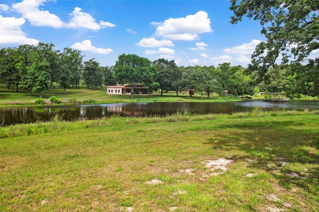 View from the other side of the pond back to the main home. An abundance of opportunity on this side!