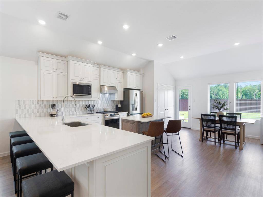 The breakfast bar features a quartz countertop, built-in sink and seating for five. The perfect gathering spot when hosting your guests.