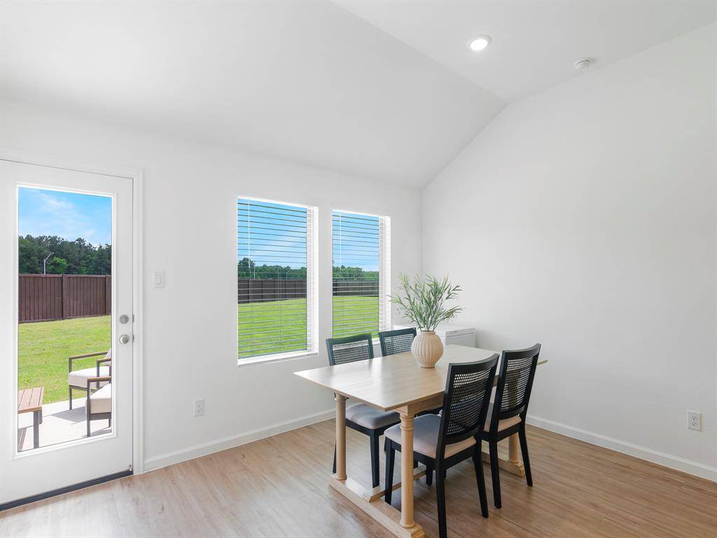 This cheery breakfast room offers a cozy spot to dine while overlooking the expansive backyard.