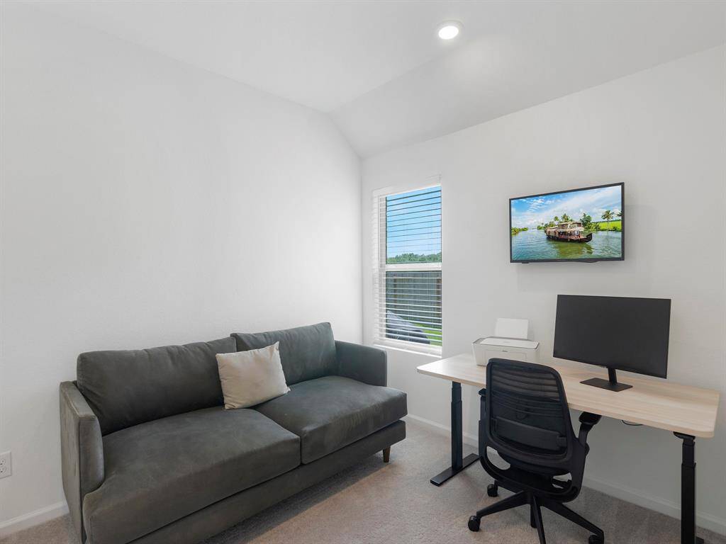 This bedroom is currently used as a home study, offering a quiet and flexible space for work.