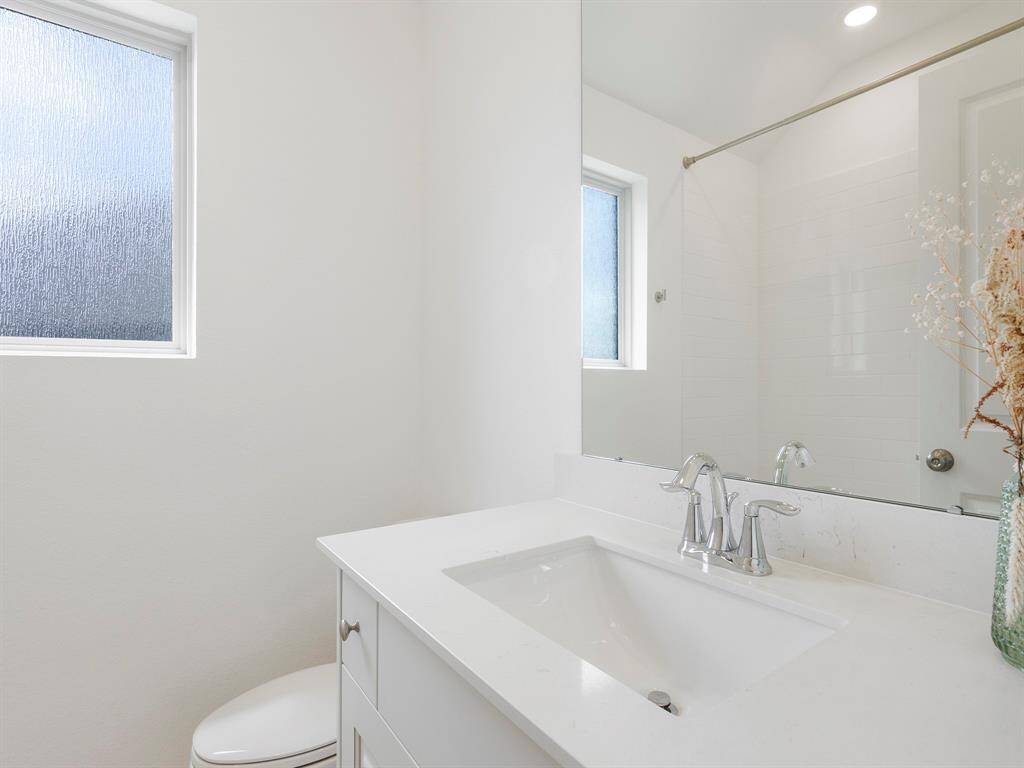 The secondary bathroom offers a clean, functional layout with quality finishes and a bathtub & shower combo, ideal for guest or family use.