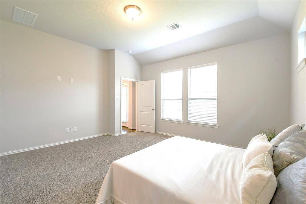 VIEW OF PRIMARY BEDROOM FROM BATHROOM