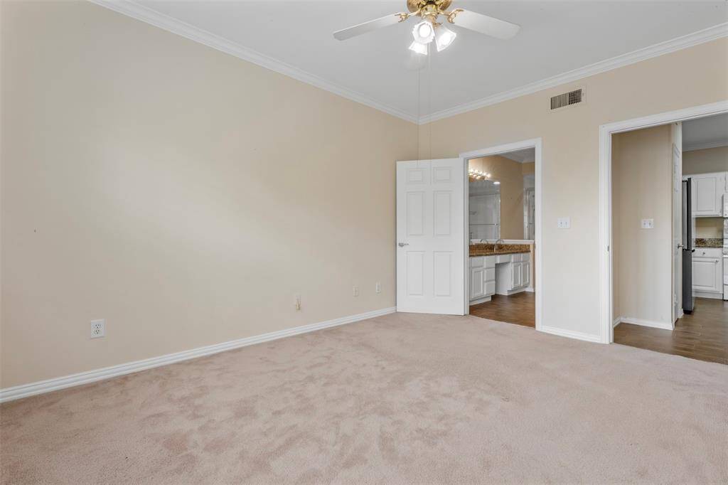 Primary bedroom with ensuite primary bathroom and walk-in closet
