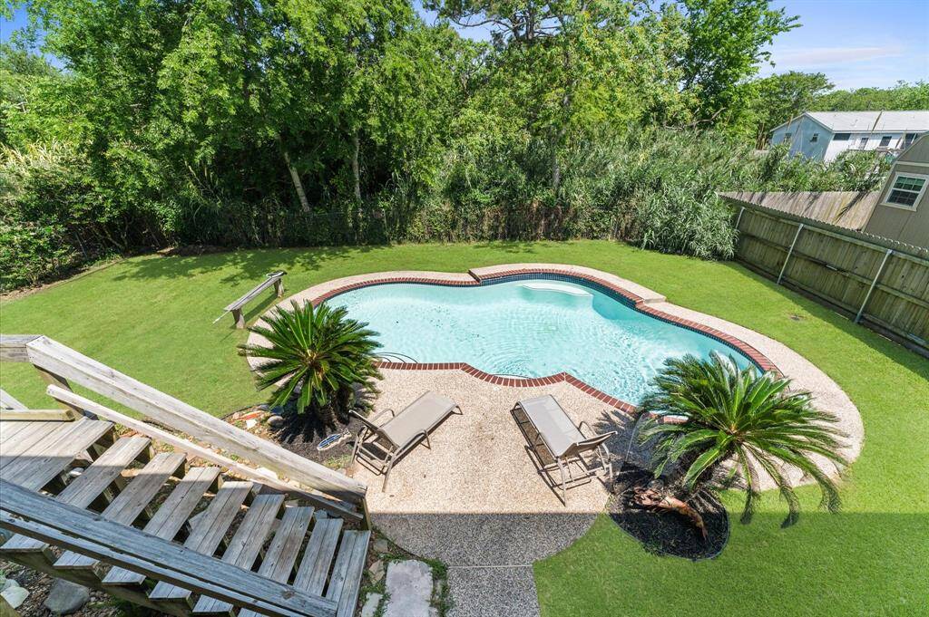 Mature landscaping in the backyard allows for a private and relaxing time around the pool