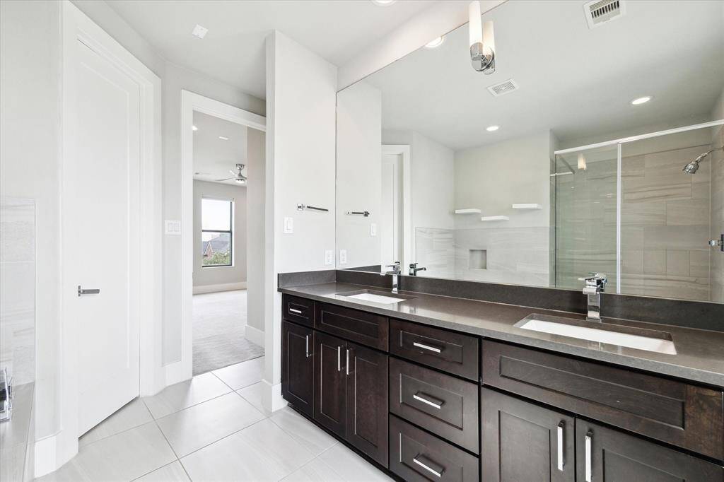 Gorgeous primary ensuite bathroom with double sinks and quartz countertops.