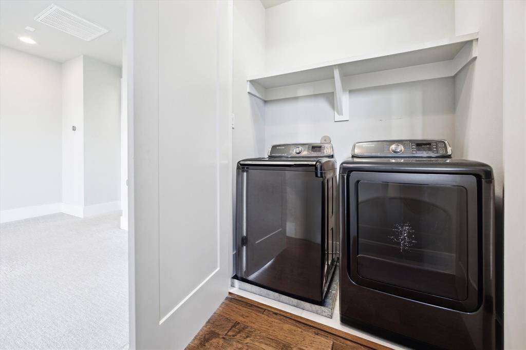 Utility room on the third floor between bedrooms, with immaculate Samsung washer and dryer.