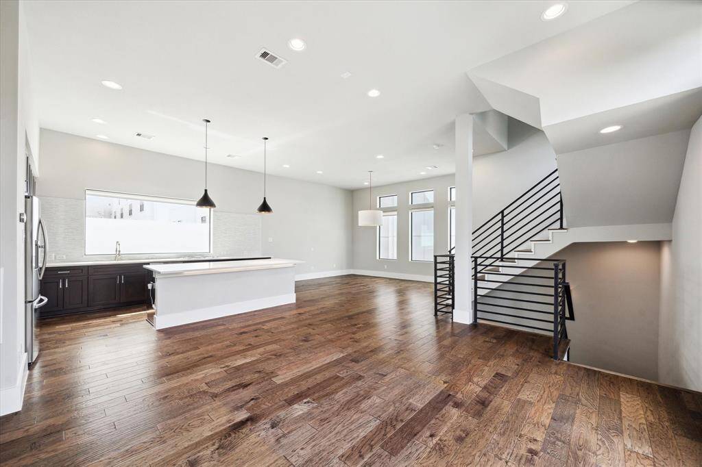 A gorgeous and bright living area boasting a free-flowing floor plan, modern finishes & fixtures, and more! You will love the stylish light fixtures in the kitchen and living room.