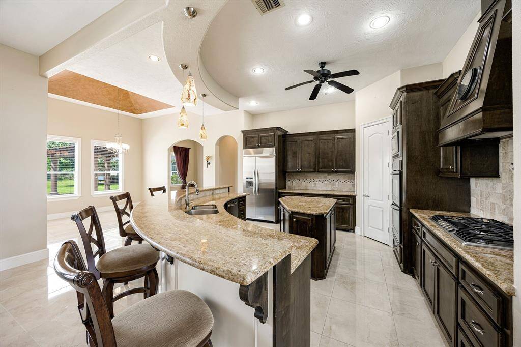 The kitchen has a gas range and stainless appliances along with a double oven. Enjoy views of your backyard while cooking and entertaining.
