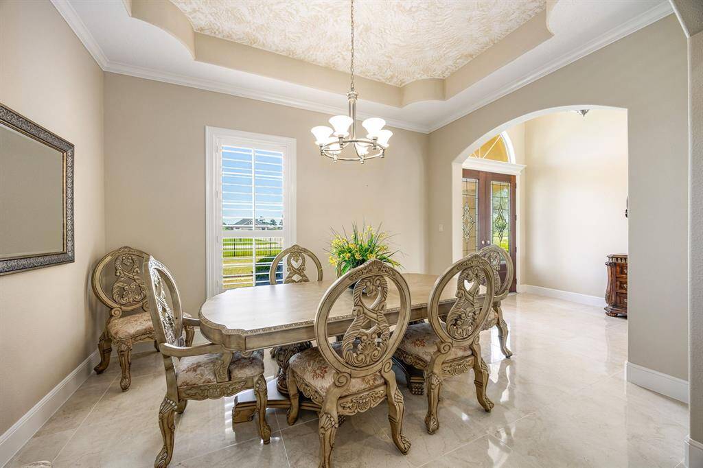 This front formal dining room exudes elegance and can be tailored with your own lighting style. Dining furniture is available from the seller.