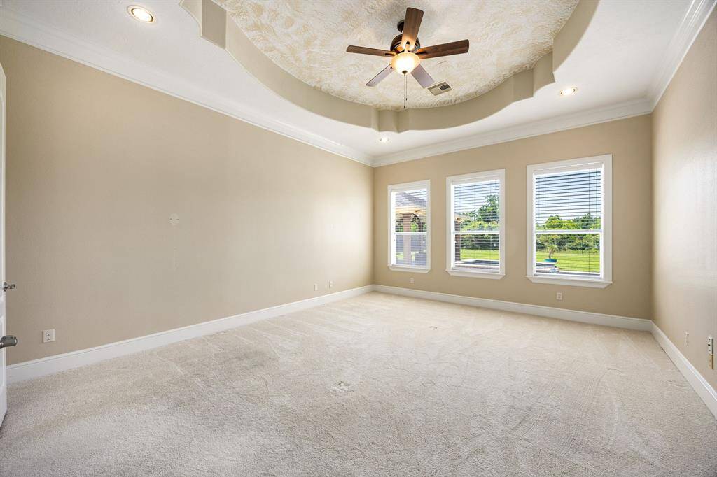 The spacious primary bedroom offers serene views of the backyard and pool, with an ensuite bath and a generous walk-in closet that are sure to impress.