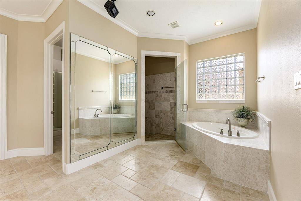 Primary bathroom features a separate soaking tub and large walk-in shower.