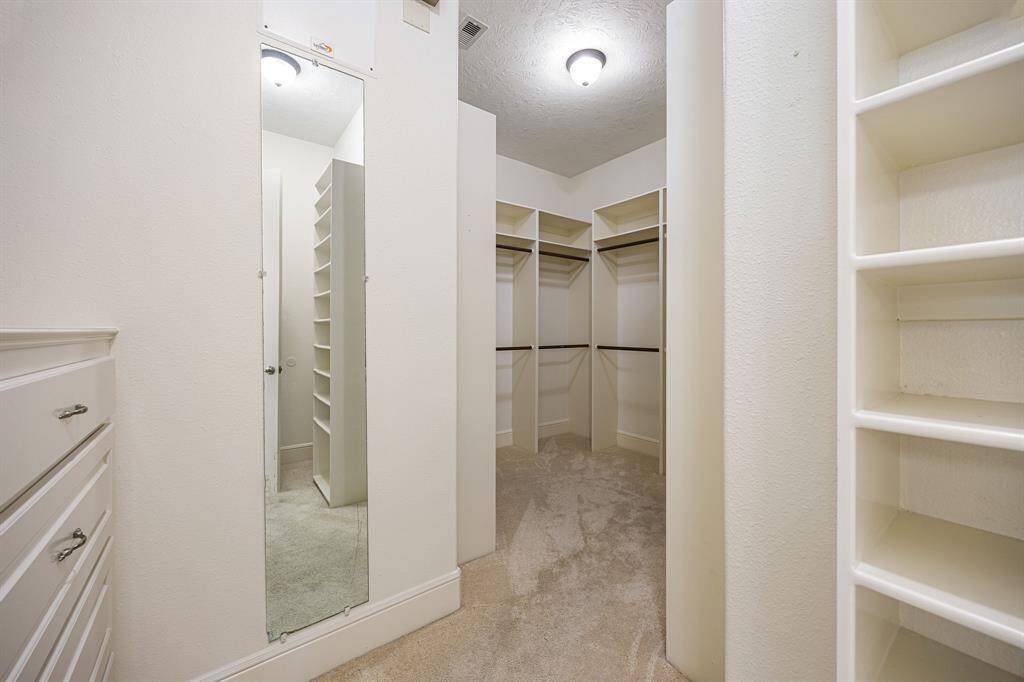 With plenty of room and thoughtful design, the primary closet has everything you need for effortless organization.