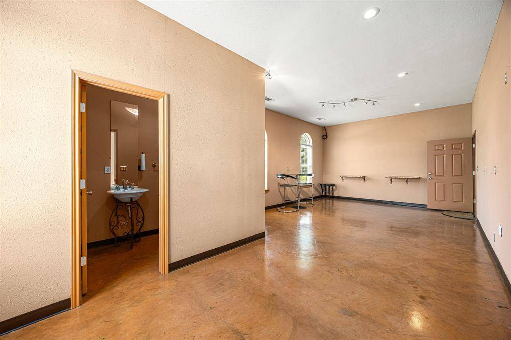 Perfect for an office or a small apartment, this space boasts stained concrete floors and tranquil views of the pool area.