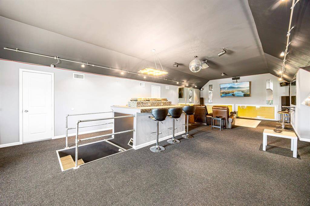 The island functions as both a buffet station and a sit-up bar, offering versatile seating and serving space.