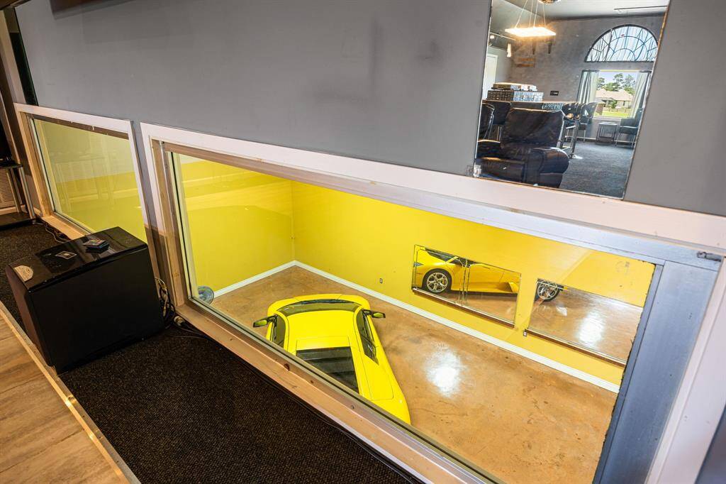 Large windows offer views overlooking the downstairs garage space.