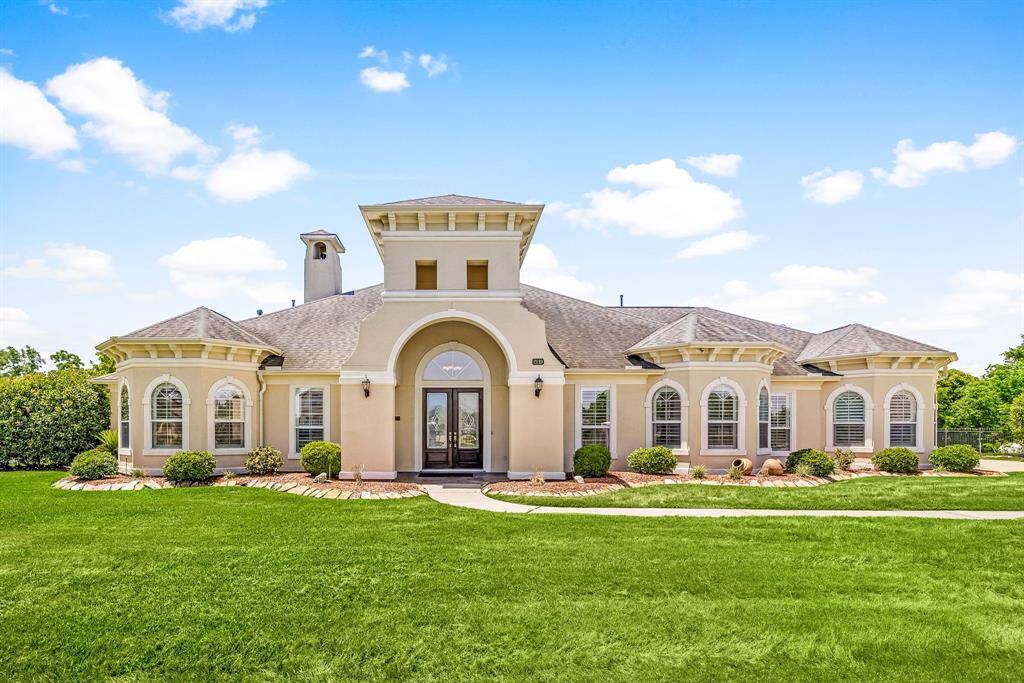 The front yard features vibrant, green grass and thoughtfully designed, low-maintenance landscape beds that create a welcoming first impression.