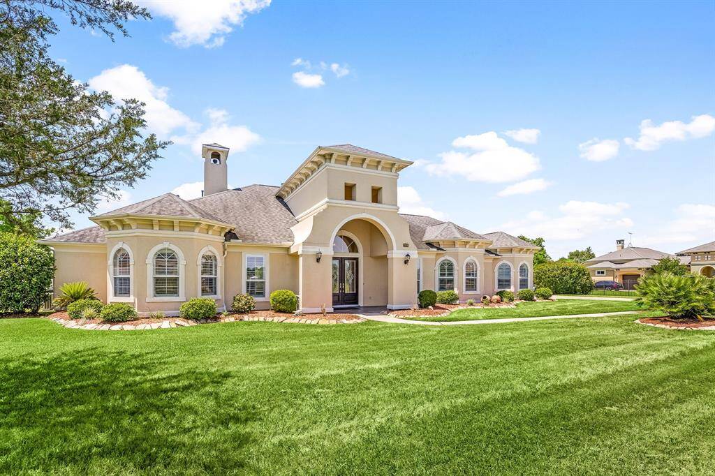 A stunning blend of modern design and classic charm, this elegant home features a neutral stucco finish and a meticulously detailed front elevation.