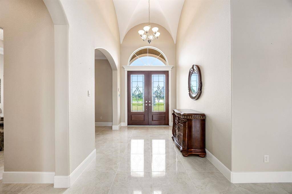 Polished tile flooring highlights the foyer, which opens directly into the formal dining room for a spacious and connected feel.
