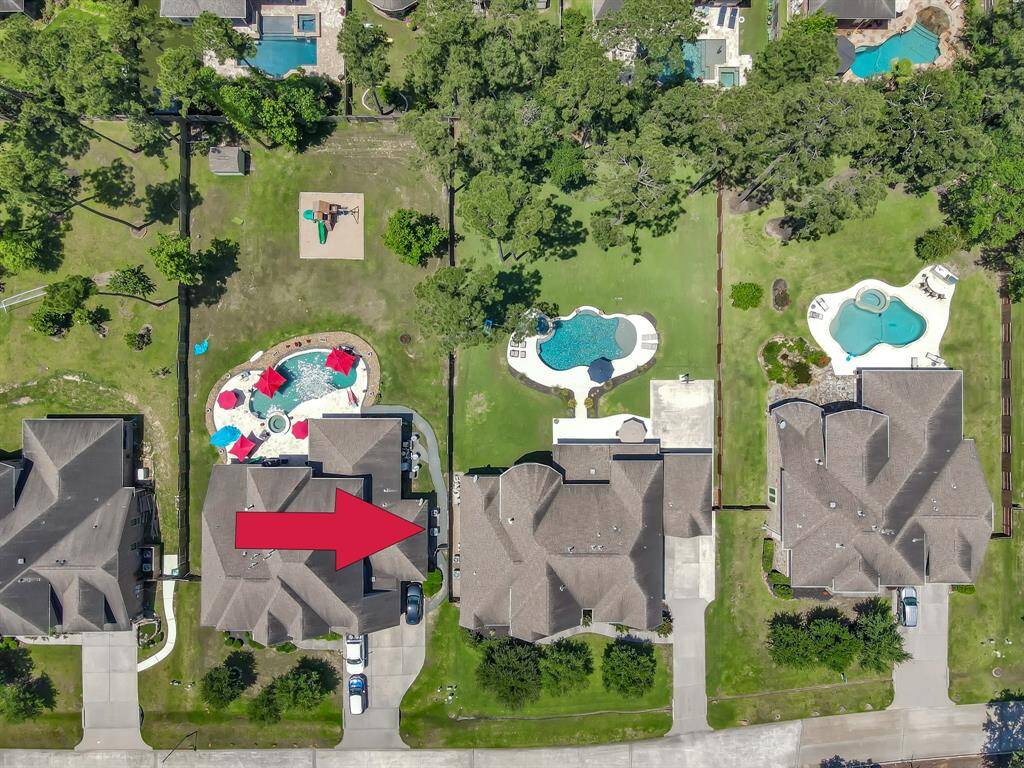 This aerial photo pinpoints this home as it sits within the neighborhood. The home and property  is well-maintained and inviting and situated on a half acre lot.